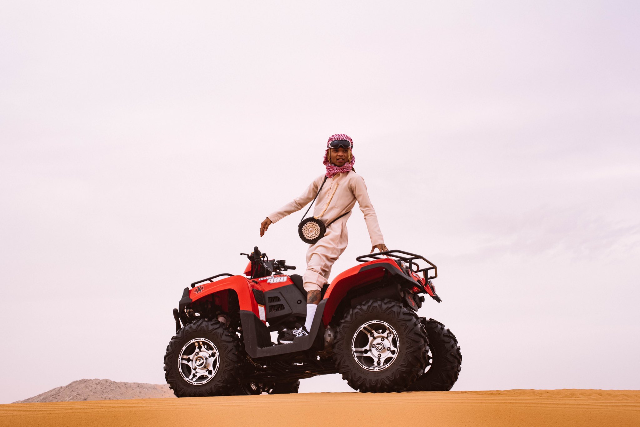 on a sandy dubai dune with a motorcade