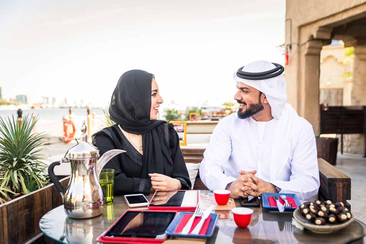 an arab man and woman in kandura